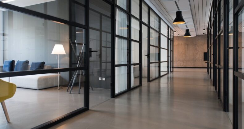 glass paneled long wooden floored hallway